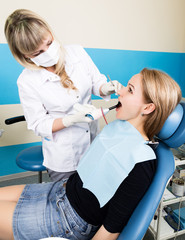 The reception was at the female dentist. Doctor examines the oral cavity on tooth decay. Caries...