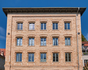 classic brickwall building facade with light green windows