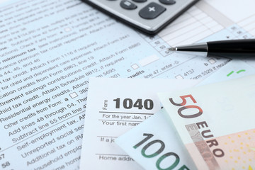 Fototapeta premium 1040 Income Tax Form and euro bills, close up