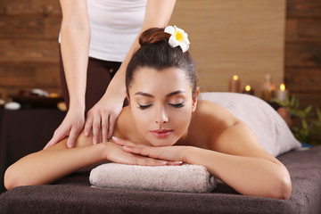 Obraz na płótnie Canvas Beautiful young girl having massage in spa salon