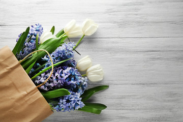 Hyacinth in paper bag on wooden background