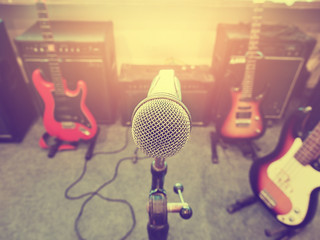 Microphone in a recording studio or concert hall with guitar.
