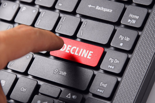 Finger choosing DECLINE button on keyboard