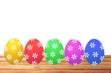 Color painted Easter eggs on wooden table on white background