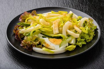 Salad with squid, cucumbers and eggs.