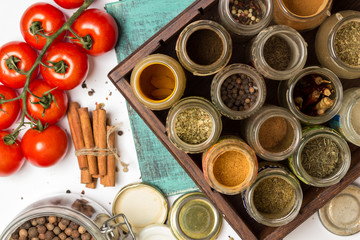 Fototapeta na wymiar Closeup spices and herbs jars. Food, cuisine ingredients. Wooden box.