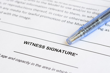Closeup of witness signature area on a document with artistic shallow depth of field.
