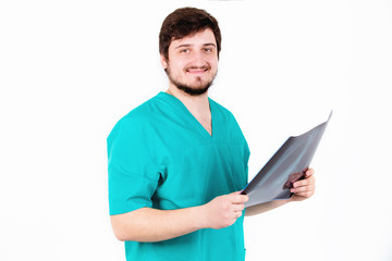 A young physician radiologist examines the picture, the white ba
