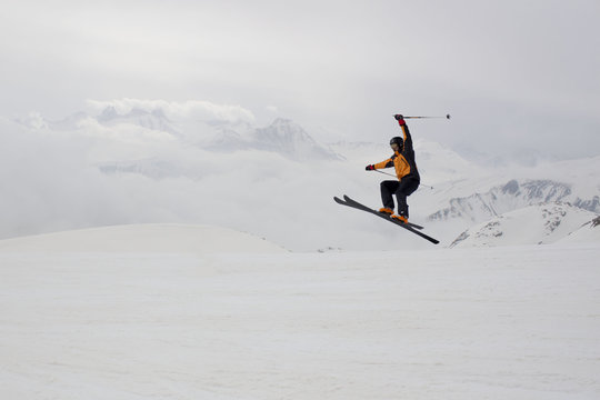 skier jumping with a range mountain background