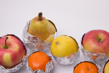 Juicy fruit, yellow pear, apple, lemon and orange tangerines wra