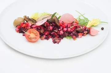 Vinaigrette Russian Salad made of chopped beets, carrots, onion, beans, peas, seasoned with...