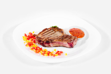 Steak on a plate on a white background