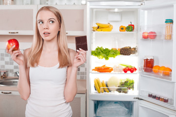 Young blonde at home near fridge