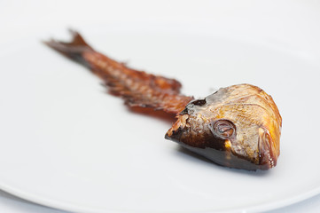 Smoked Fish Bone on a White Plate
