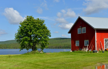 Obraz premium Northern landscape with red barn. Northern Finland, Lapland