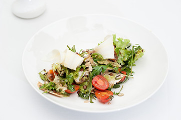 Parsnip Salad with Sectioned Tomato Served on a white plate
