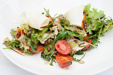 Parsnip Salad with Sectioned Tomato Served on a white plate
