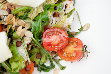 Parsnip Salad with Sectioned Tomato Served on a white plate
