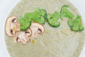 Closeup Mushrooms Cream Soup with Pieces of Broccoli and Slices of Mushrooms
