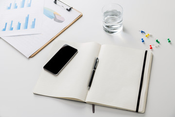 Desk with copybook and phone