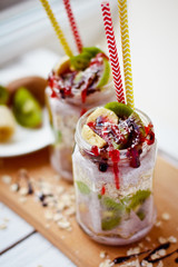 Healthy breakfast over night oats with fresh fruit kiwi and bananas in a glass jar. Beautiful oatmeal