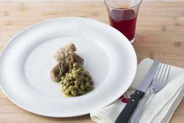 beef stew with peas served on a white plate