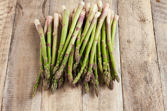 fresh asparagus on wood background