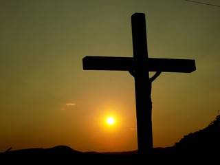 Cross with Jesus Christ and sunset