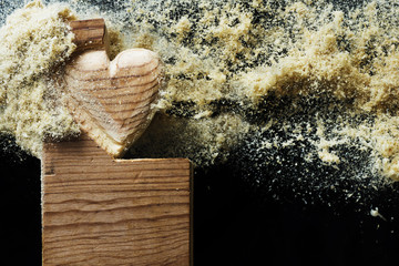 Flying sawdust over a wood heart