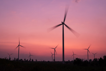 Obraz premium wind turbines spinning at twilight