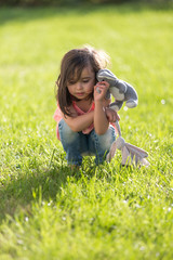 Fototapeta premium Sweet little girl outdoors playing