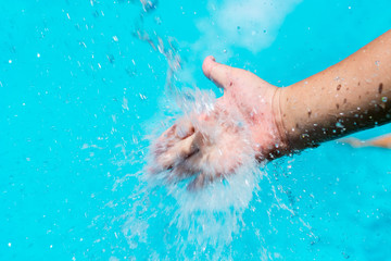 hands under the stream of splashing water