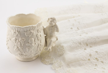 Vintage christening cup and gown isolated on white