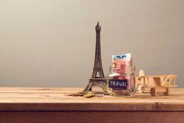 Travel to Paris, France concept with Eiffel Tower souvenir and wooden airplane toy. Planning summer...