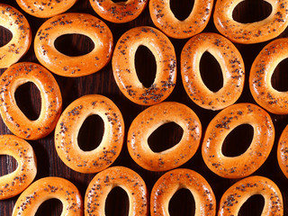many bagels with poppy seeds on a table
