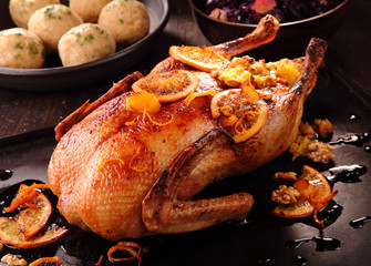 Whole roast duck with orange slices