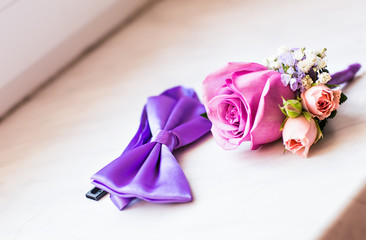 Gentle groom's boutonniere and bow-tie
