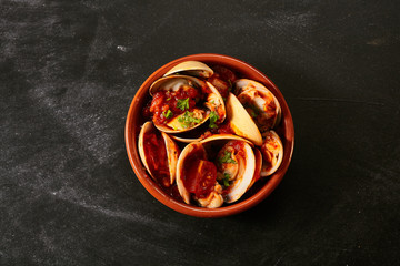 Bowl of Venus shell clams in a spicy sauce