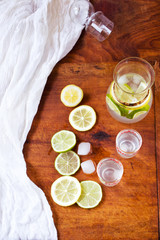 Healthy drink with lemons and lime on wooden table