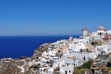 Fototapeta na wymiar Santorini, one of the Cyclades islands in the Aegean Sea. The white houses of its 2 principal towns, Fira and Oia, cling to cliffs above an underwater caldera. They overlook the clear Aegean sea ...