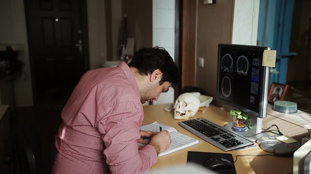 Curious doctor looking into a skull