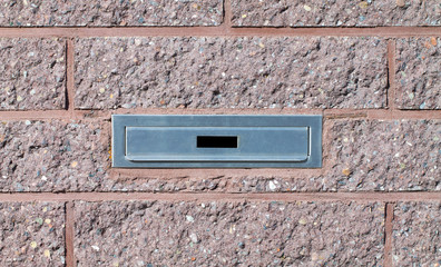 Mailbox built-in into pink brick wall