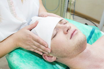 Obraz premium man in the mask cosmetic procedure in spa salon