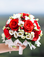 Beautiful wedding bouquet in hands of the bride close-up