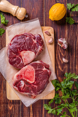 Raw fresh beef meat cross cut for ossobuco on cutting board with