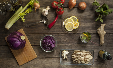 red cabbage, tomatoes, garlic and onions on old wooden table