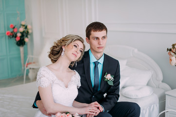 Happy couple. Wedding photo shoot in the white studio with wedding decor kisses, hugs