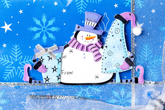 close-up image of snowman sticker on christmas box.