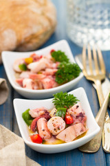 seafood salad in bowl on blue wooden background