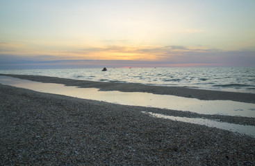 Beautiful sunrise on the sea beach, fishing